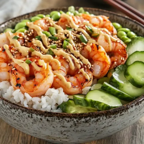 A fresh shrimp poke bowl with colorful toppings and sauce.